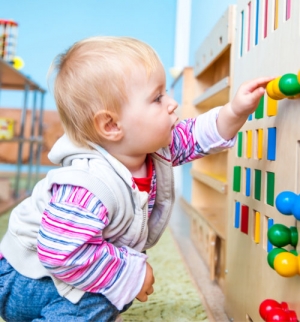 a toddler playing inside a child care facility