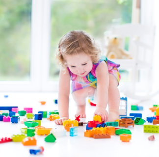 a toddler playing lego toys
